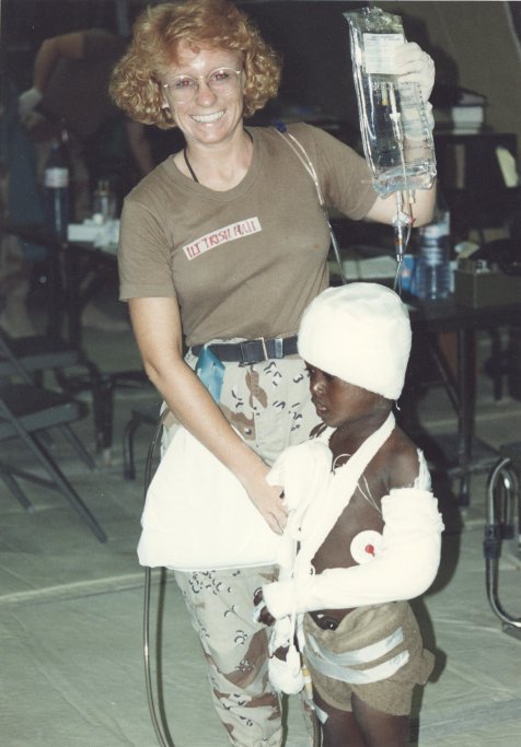 Lt. Patricia Hall with a wounded Somali boy